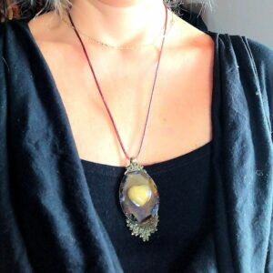 Collier avec pendentif socle bronze ovale et en son centre une citrine en forme de coeur et piétersites tout autour